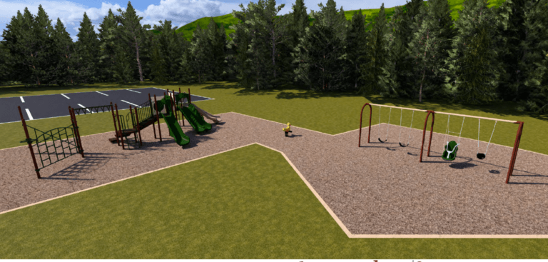 May show: Playground with climbing structures, slides, swings, and a spring rider on a grassy area near a parking lot, surrounded by trees and hills.